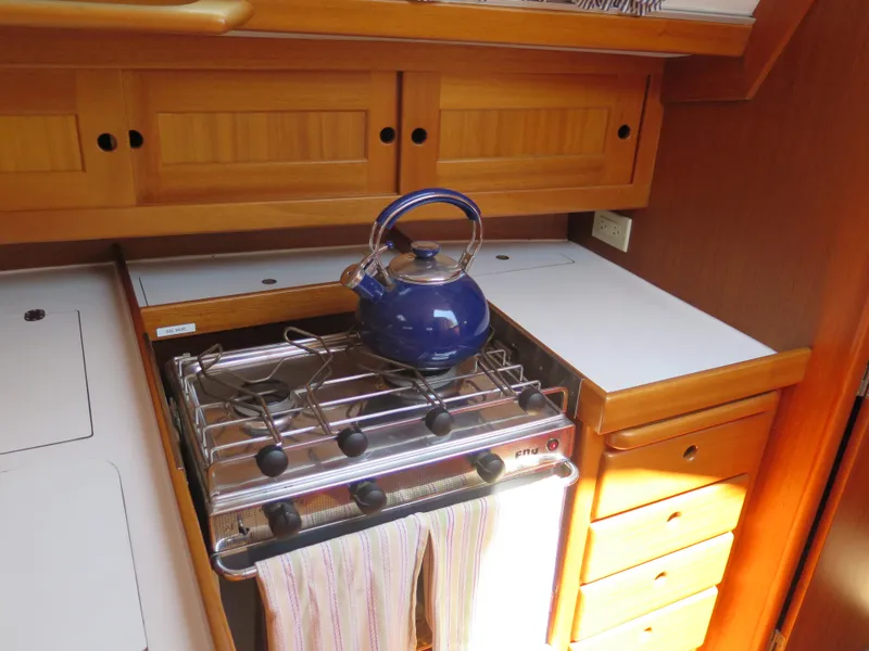 Slide: The Image of 2002 Arcona 355 Sloop kitchen with stove and blue kettle - 17