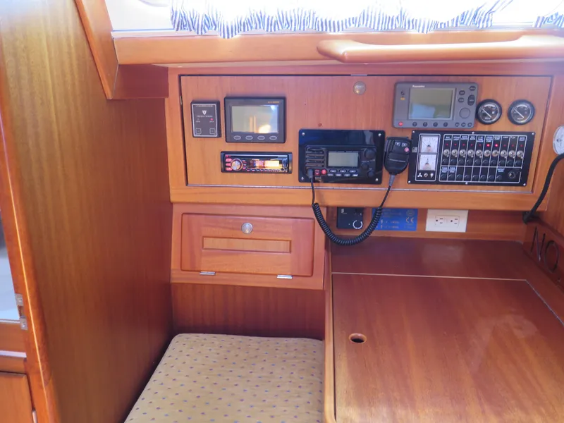 Slide: The Image of Navigation station of a 2002 Arcona 355 Sloop with control panels and instruments. - 23