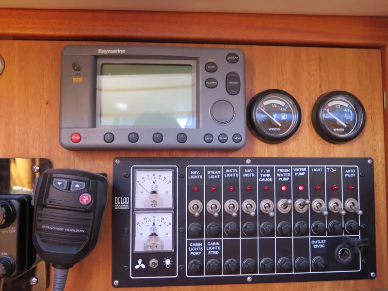 Slide: The Image of Control panel of a 2002 Arcona 355 Sloop with navigation and communication equipment. - 26