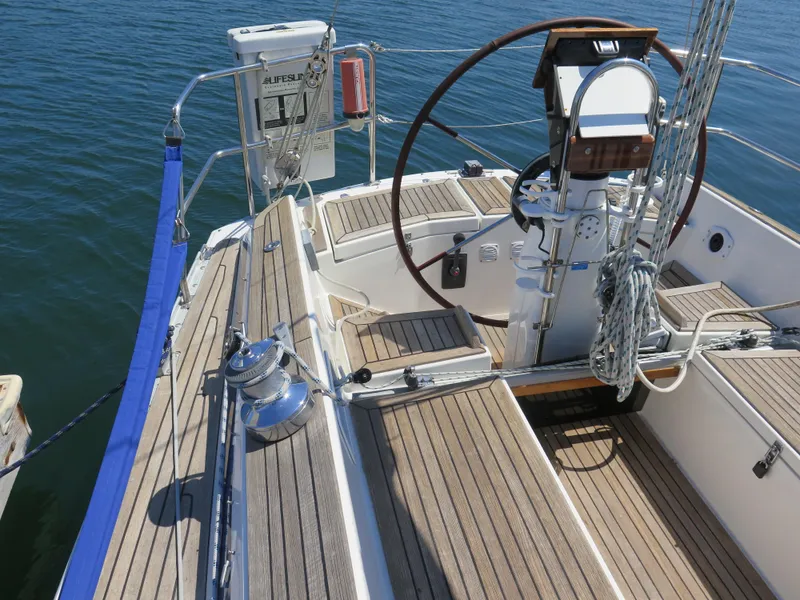 Slide: The Image of 2002 Arcona 355 Sloop sailboat cockpit with wooden deck and steering wheel. - 34
