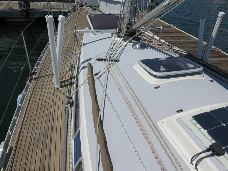 Slide: The Image of Arcona 355 Sloop 2002 sailboat deck with wooden trim and rigging at dock. - 36