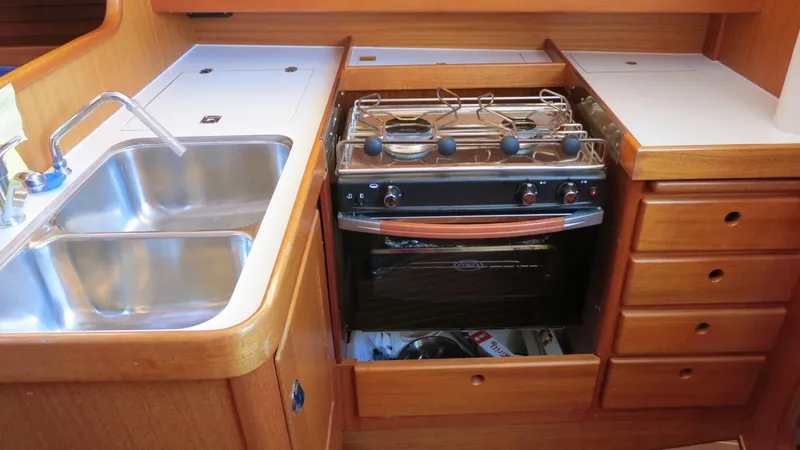 Slide: The Image of 2002 Arcona 355 Sloop kitchen with stainless steel sink and stove - 4