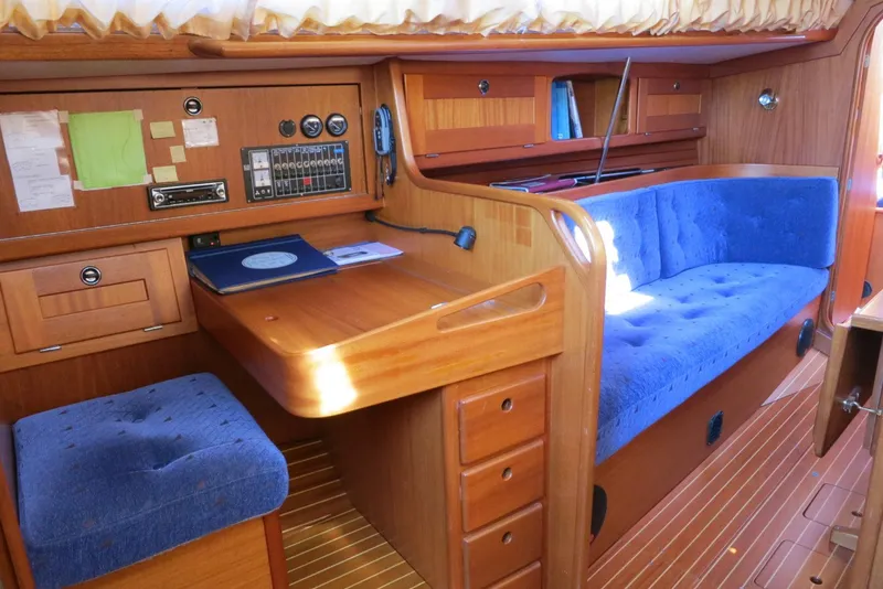 Slide: The Image of Interior of a 2002 Arcona 355 Sloop with wooden furnishings and blue upholstery. - 5