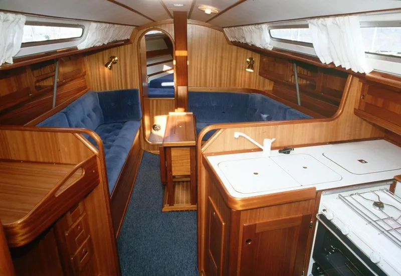 Slide: The Image of Interior of 2002 Arcona 355 Sloop with wooden finish and blue upholstery. - 6