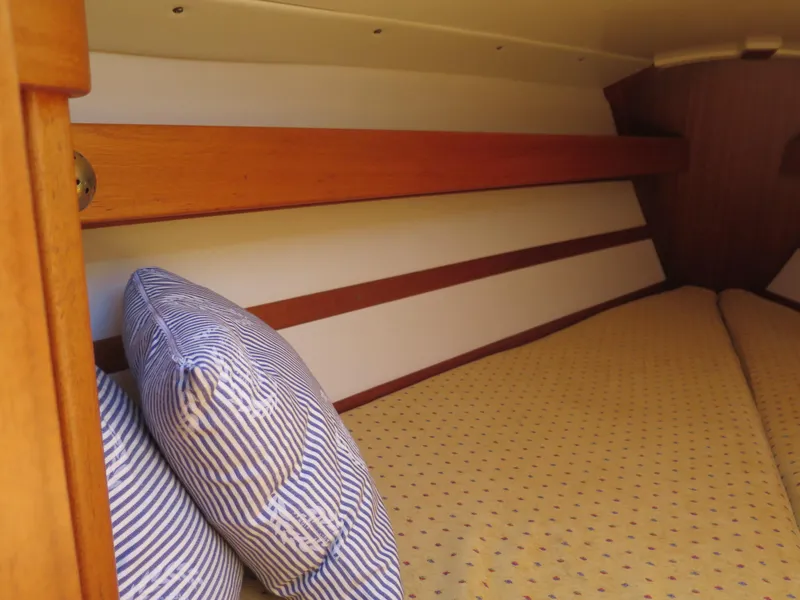Slide: The Image of Cozy cabin interior of a 2002 Arcona 355 Sloop with striped pillows and wooden accents. - 7