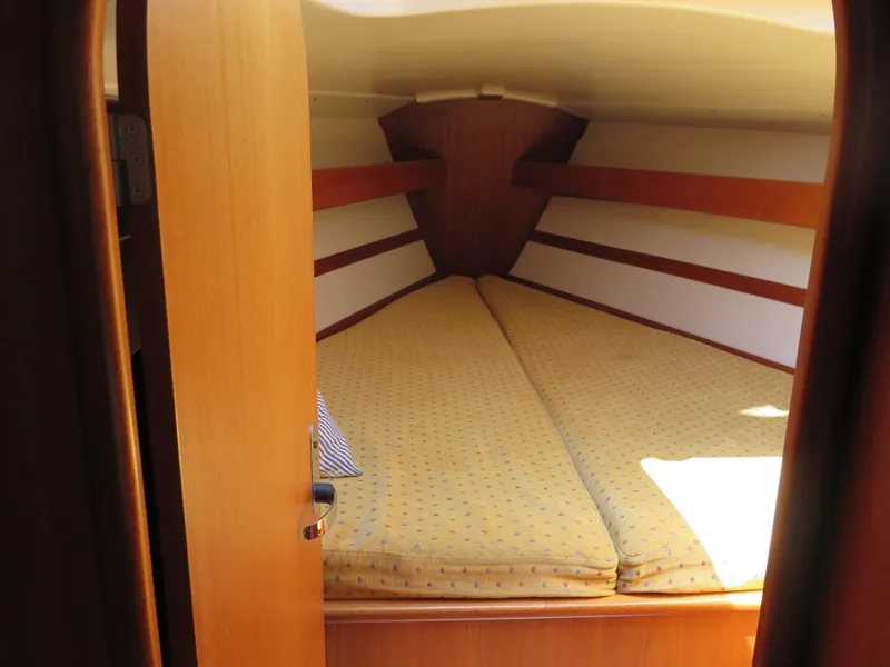 Slide: The Image of 2002 Arcona 355 Sloop cabin with cozy V-berth and wooden interior. - 8
