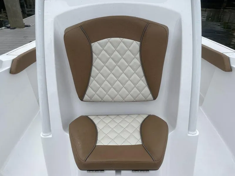 Slide: The Image of 2024 Polar 220 CC boat seat with brown and white diamond-stitched upholstery. - 11