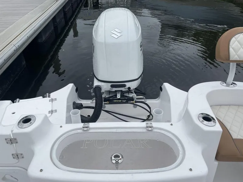 Slide: The Image of 2024 Polar 220 CC boat with Suzuki outboard motor at dock. - 12