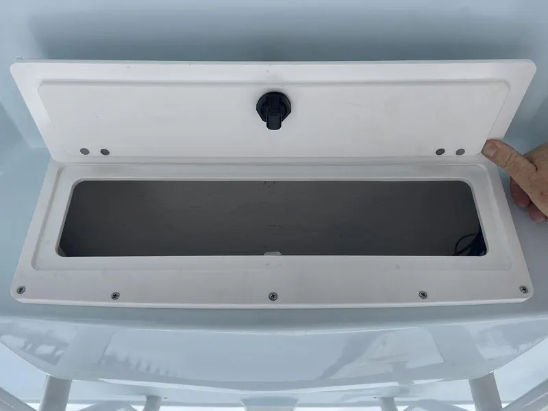 Slide: The Image of Open storage compartment on a 2024 Polar 220 CC boat. - 16