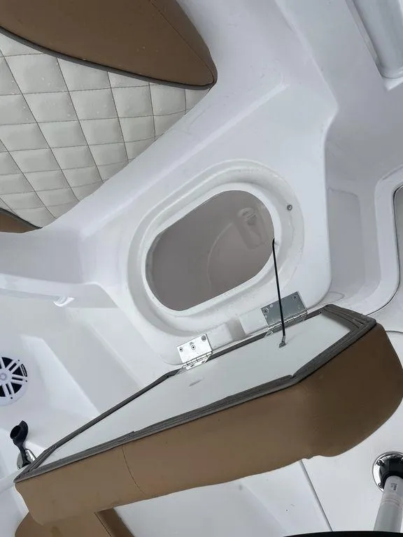 Slide: The Image of 2024 Polar 220 CC boat interior with white and brown seating. - 18