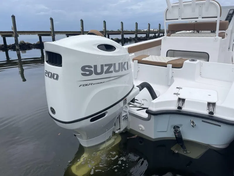 Slide: The Image of 2024 Polar 220 CC boat with Suzuki 200 outboard motor in water. - 19
