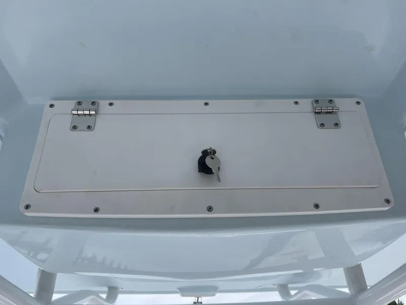 Slide: The Image of 2024 Polar 220 CC boat storage compartment with key. - 20