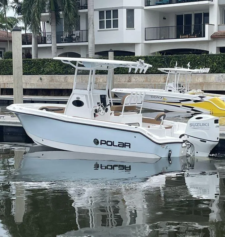 Slide: The Image of 2024 Polar 220 CC boat docked with Suzuki outboard motor. - 4