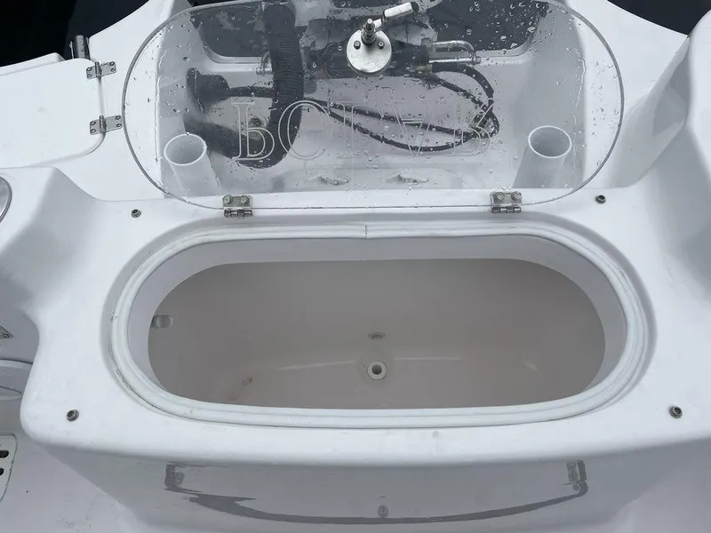 Slide: The Image of 2024 Polar 220 CC boat livewell with clear lid and white interior. - 9