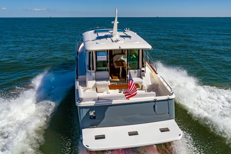 Slide: The Image of 2024 Sabre 43 Salon Express yacht cruising on open water. - 11