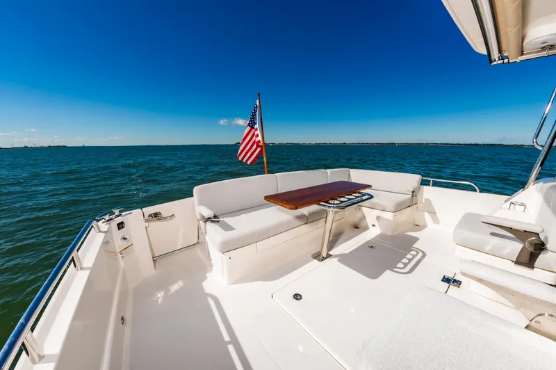 Slide: The Image of 2024 Sabre 43 Salon Express yacht deck with seating and ocean view. - 14