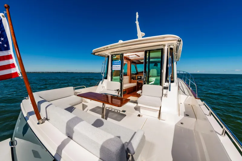 Slide: The Image of 2024 Sabre 43 Salon Express yacht with outdoor seating and ocean view. - 15