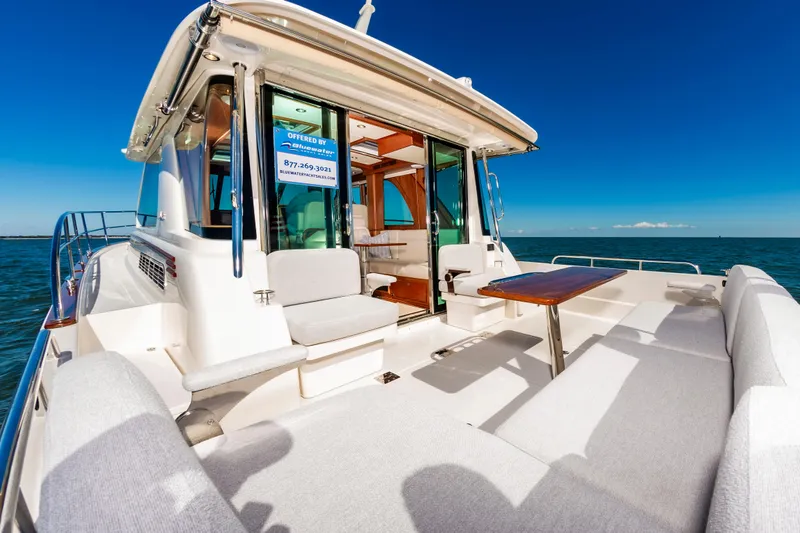 Slide: The Image of 2024 Sabre 43 Salon Express yacht with outdoor seating and ocean view. - 16