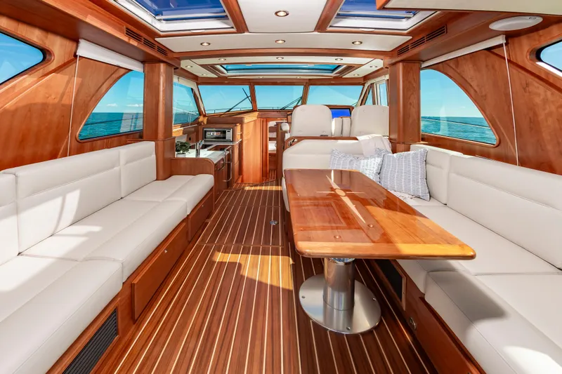Slide: The Image of Interior of 2024 Sabre 43 Salon Express yacht with luxurious seating and wooden finishes. - 22