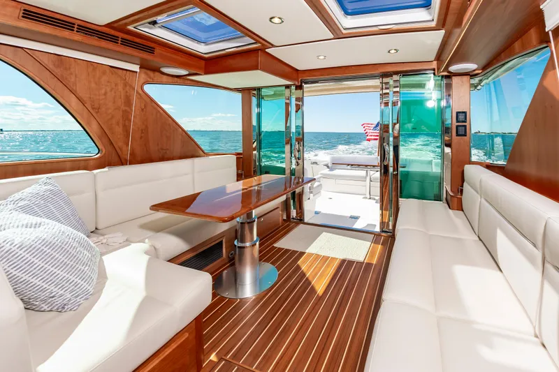 Slide: The Image of Interior of 2024 Sabre 43 Salon Express yacht with luxurious seating and ocean view. - 23