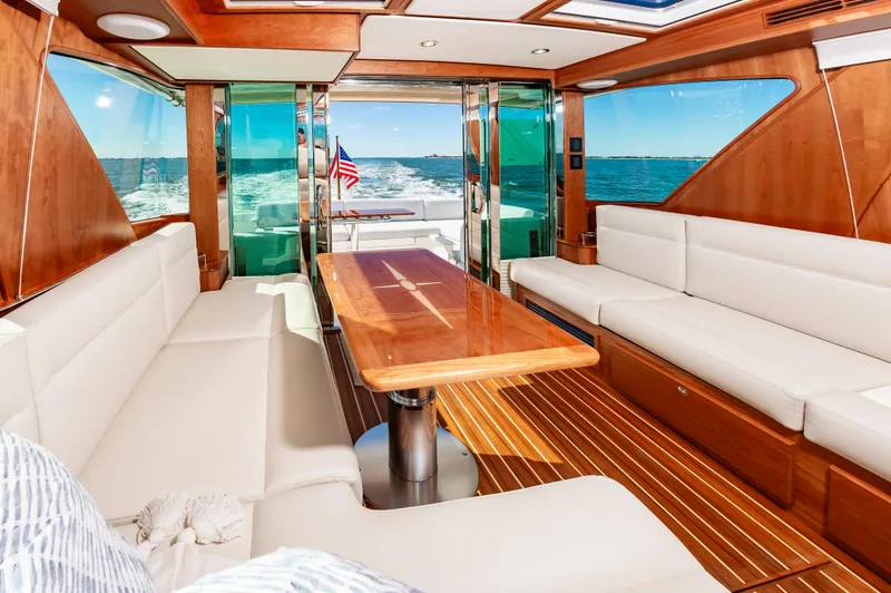 Slide: The Image of Interior of 2024 Sabre 43 Salon Express yacht with luxurious seating and wooden table. - 26