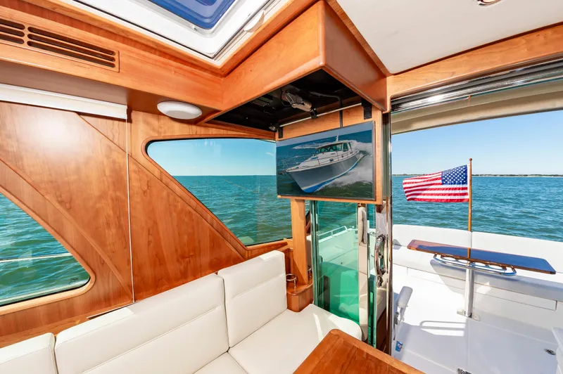 Slide: The Image of Interior of 2024 Sabre 43 Salon Express yacht with ocean view and American flag. - 27