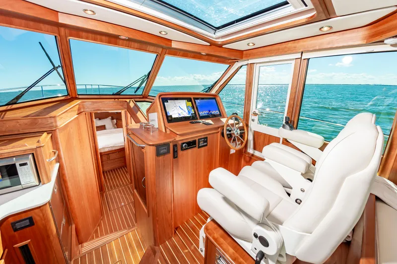 Slide: The Image of Interior of 2024 Sabre 43 Salon Express yacht with luxurious wood finish and ocean view. - 29