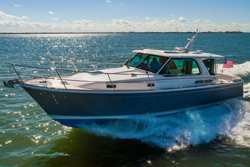 Slide: The Image of 2024 Sabre 43 Salon Express yacht cruising on open water. - 3