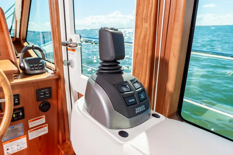 Slide: The Image of Volvo Penta joystick control on 2024 Sabre 43 Salon Express yacht with ocean view. - 31