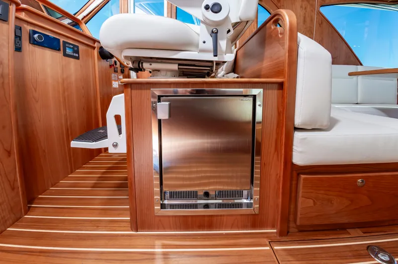 Slide: The Image of Interior of 2024 Sabre 43 Salon Express yacht with wooden finish and stainless steel fridge. - 34