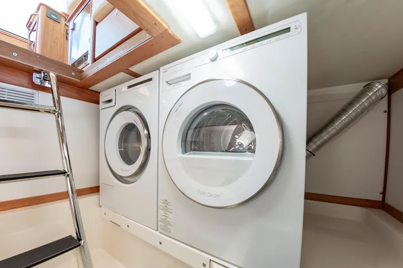 Slide: The Image of Laundry area with washer and dryer on 2024 Sabre 43 Salon Express yacht. - 37
