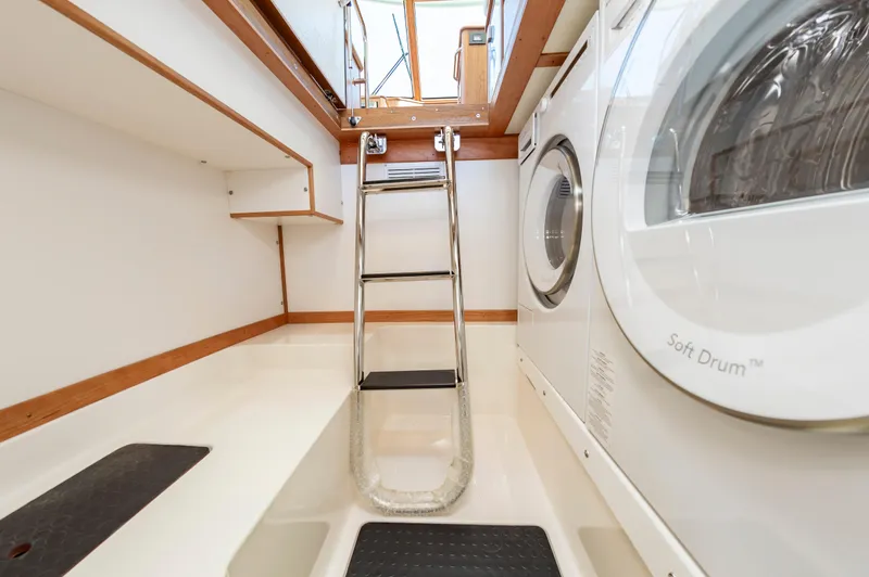 Slide: The Image of Laundry area in 2024 Sabre 43 Salon Express yacht with washer and dryer. - 38