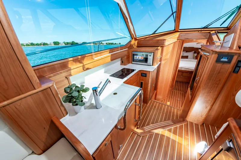 Slide: The Image of Interior of 2024 Sabre 43 Salon Express yacht with modern kitchen and wooden finishes. - 39