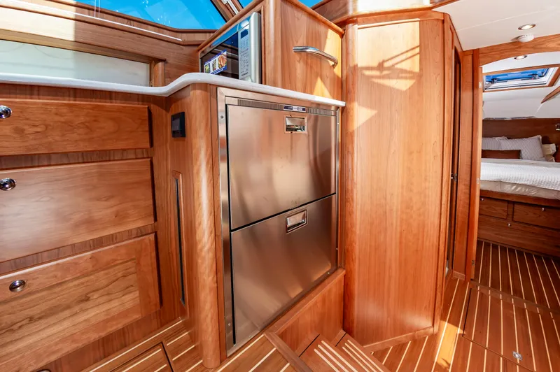 Slide: The Image of Interior of 2024 Sabre 43 Salon Express yacht with wood cabinetry and stainless steel appliances. - 42