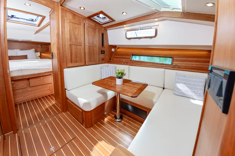 Slide: The Image of Interior of 2024 Sabre 43 Salon Express yacht with wooden finishes and cozy seating area. - 43