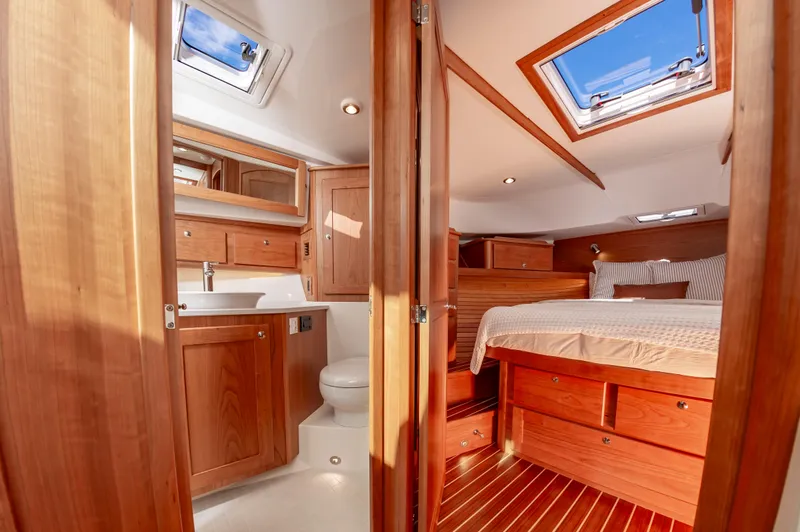 Slide: The Image of 2024 Sabre 43 Salon Express interior with wooden cabinetry, bathroom, and bedroom. - 47