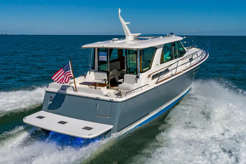 Slide: The Image of 2024 Sabre 43 Salon Express yacht cruising on open water. - 5