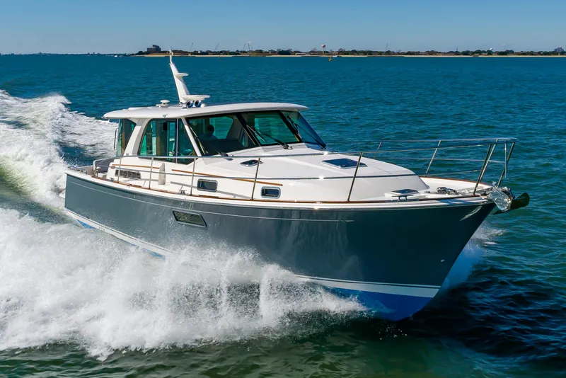 Slide: The Image of 2024 Sabre 43 Salon Express yacht cruising on open water. - 6