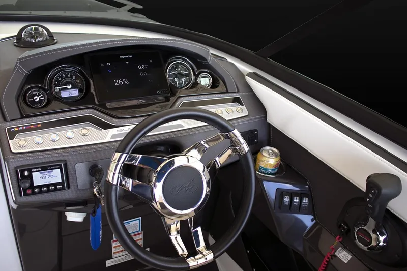 Slide: The Image of 2024 Monterey 275 Super Sport boat dashboard with steering wheel and control panel. - 13