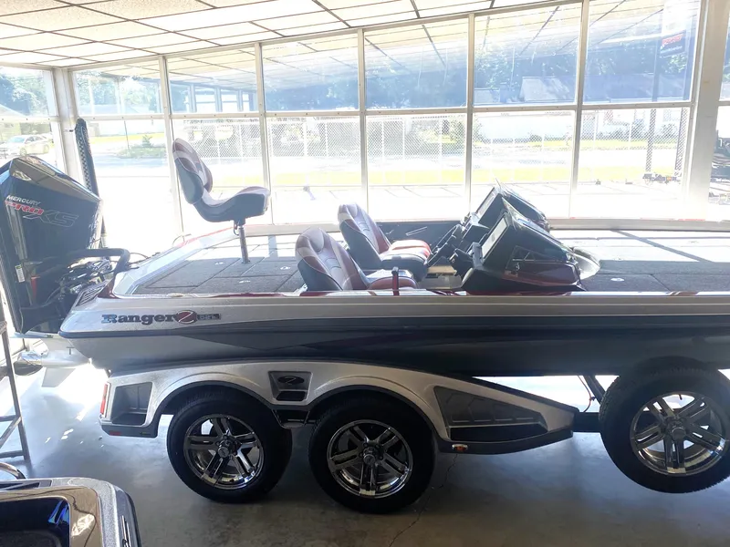 Slide: The Image of 2021 Ranger Z521L boat in showroom, featuring sleek design and dual axles. - 12