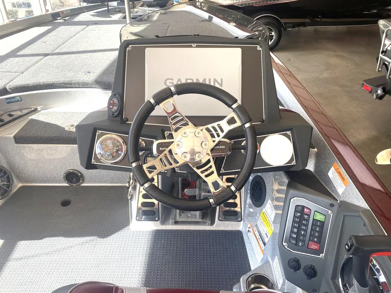 Slide: The Image of 2021 Ranger Z521L boat dashboard with Garmin display and steering wheel. - 19