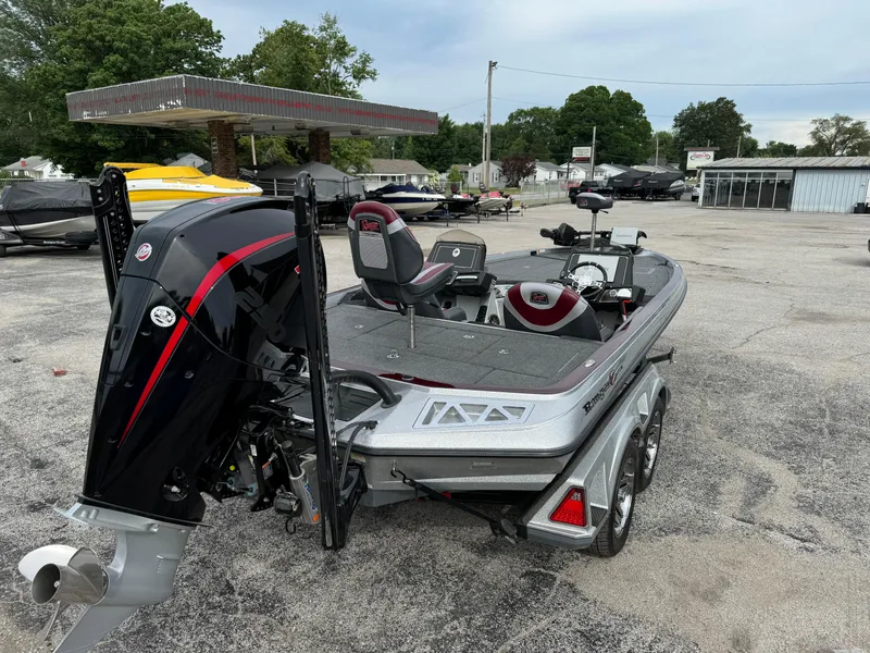 Slide: The Image of 2021 Ranger Z521L boat in a parking lot, featuring a sleek design and powerful engine. - 2