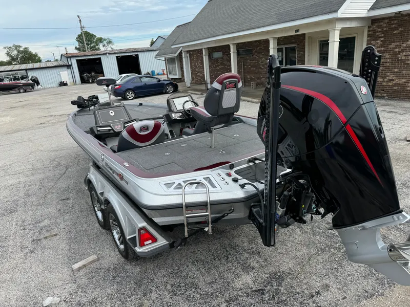 Slide: The Image of 2021 Ranger Z521L boat with motor, parked outside a building. - 4