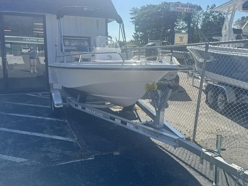 Slide: The Image of 2024 Edgewater 158CS boat on trailer outside dealership. - 1