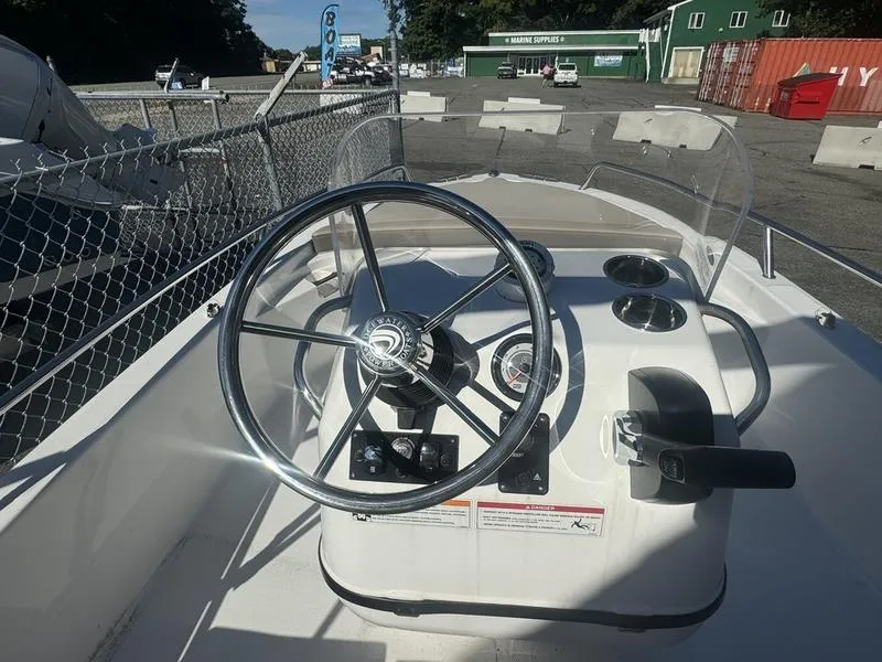 Slide: The Image of 2024 Edgewater 158CS boat dashboard with steering wheel and controls. - 4