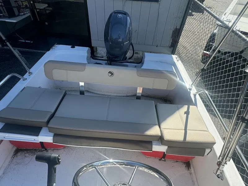 Slide: The Image of 2024 Edgewater 158CS boat interior with cushioned seating and steering wheel. - 7