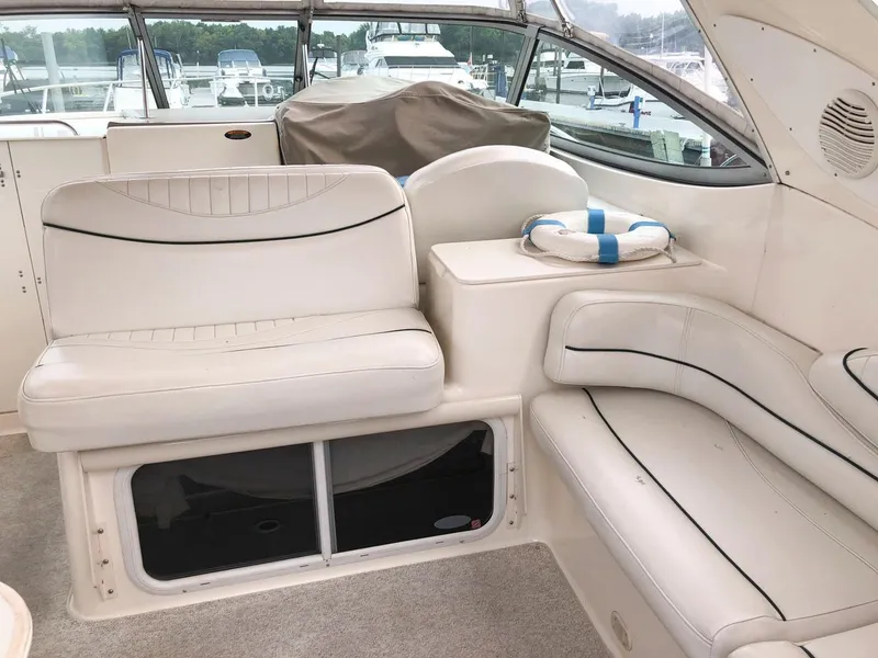 Slide: The Image of Interior seating area of a 2002 Maxum 3300 SCR boat with white upholstery. - 12