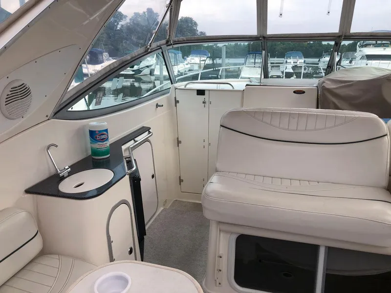 Slide: The Image of 2002 Maxum 3300 SCR boat interior with seating and sink. - 13