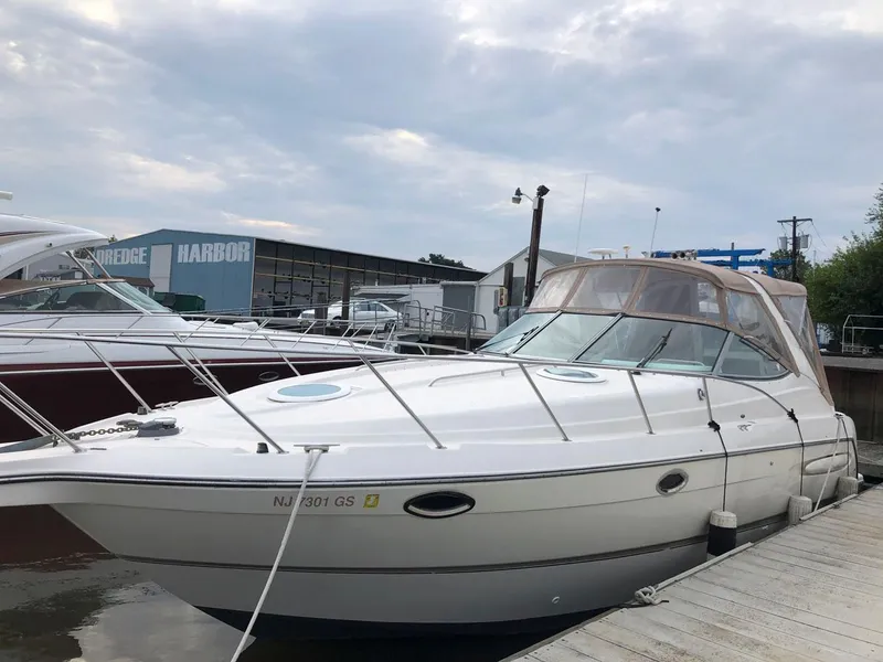 Slide: The Image of 2002 Maxum 3300 SCR boat docked at a marina. - 2