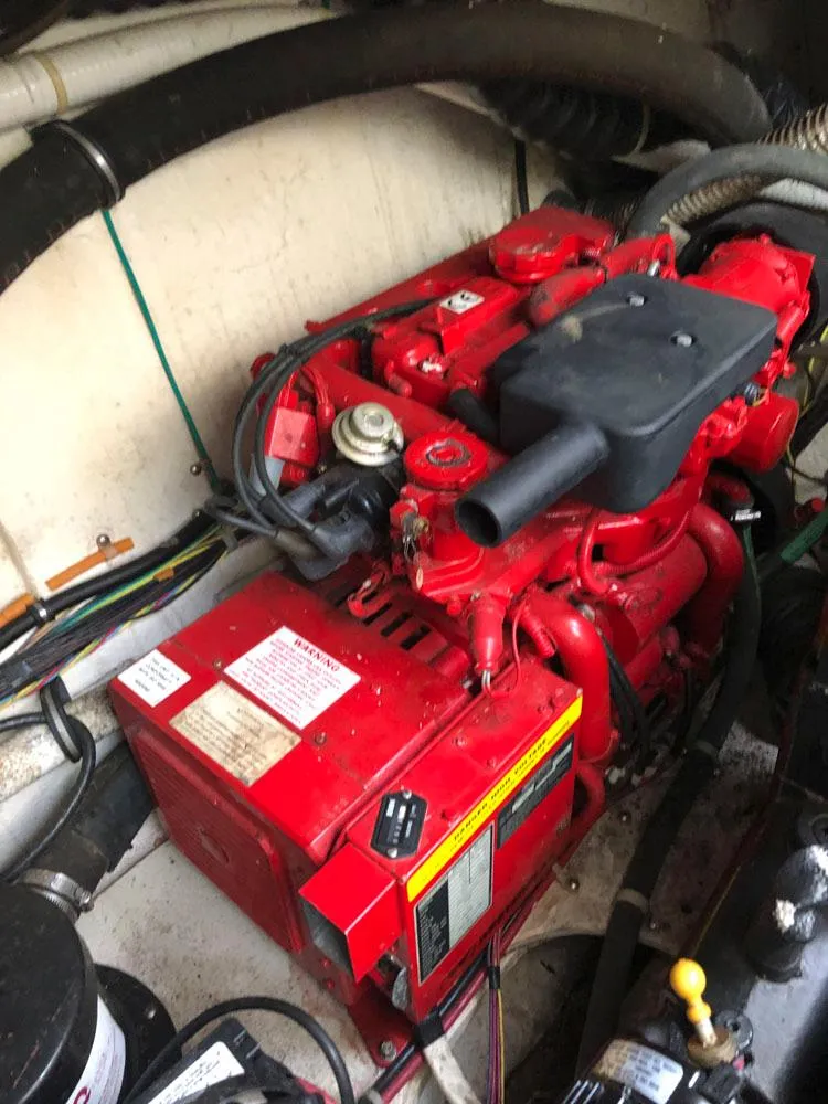 Slide: The Image of Engine compartment of a 2002 Maxum 3300 SCR boat, featuring a red engine. - 21
